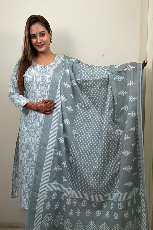 Woman holding a patterned fabric against a plain background