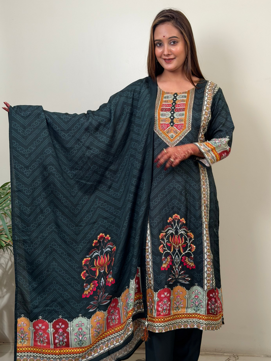 Woman holding a dark blue embroidered traditional outfit against a plain background