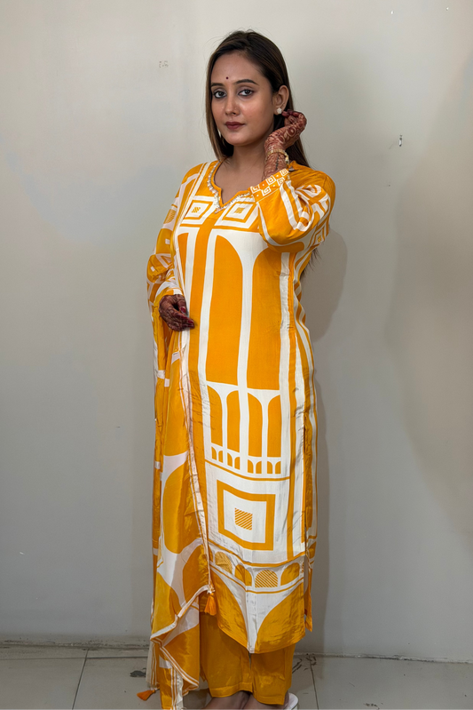 Woman wearing a yellow and white patterned kurta against a plain background