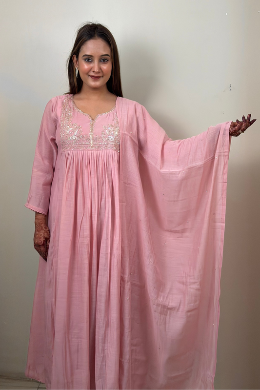 Woman wearing a pink dress with a plain background